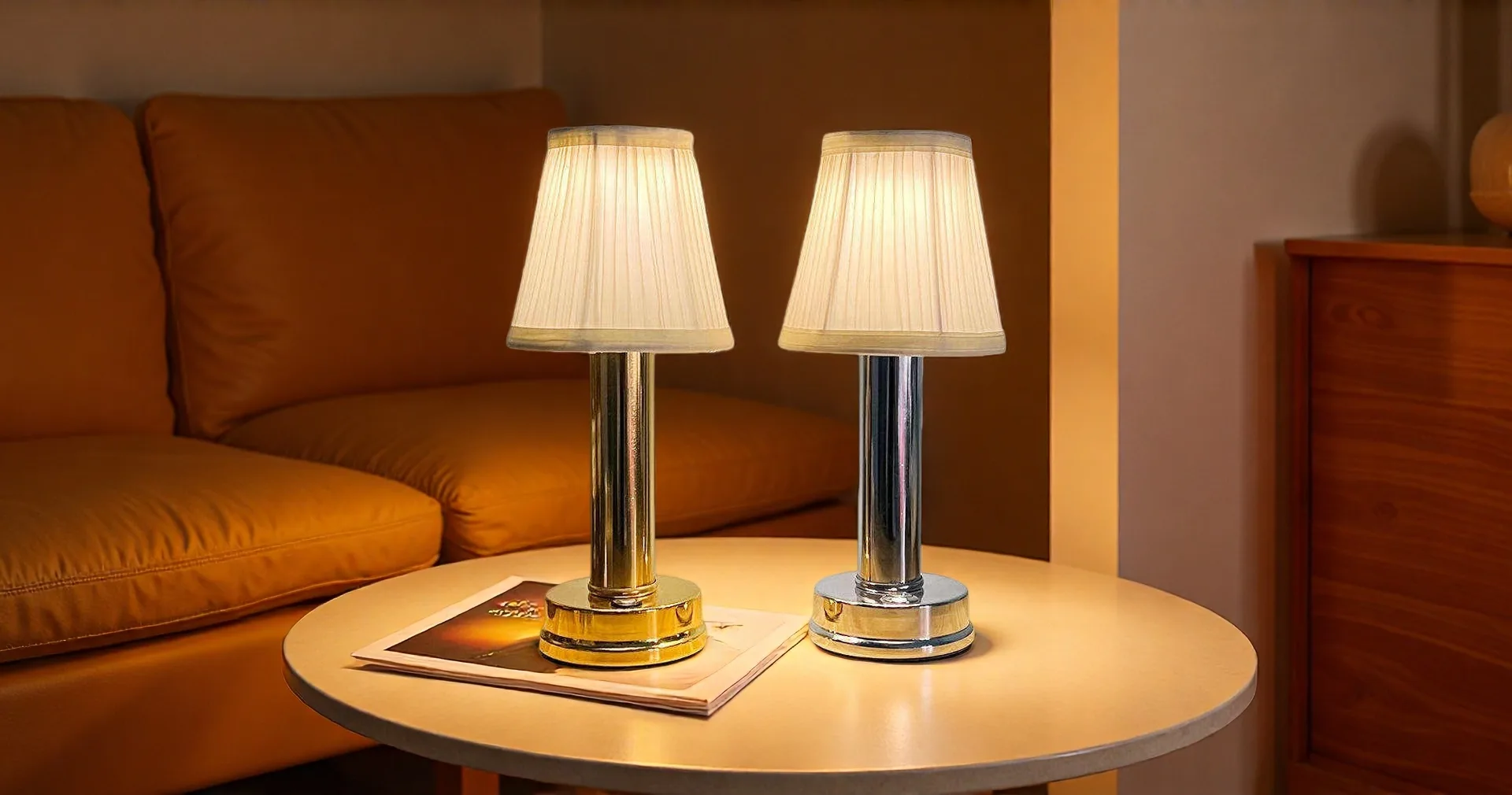 Gold and silver rechargeable table lamps with fabric shades on a rustic tabletop